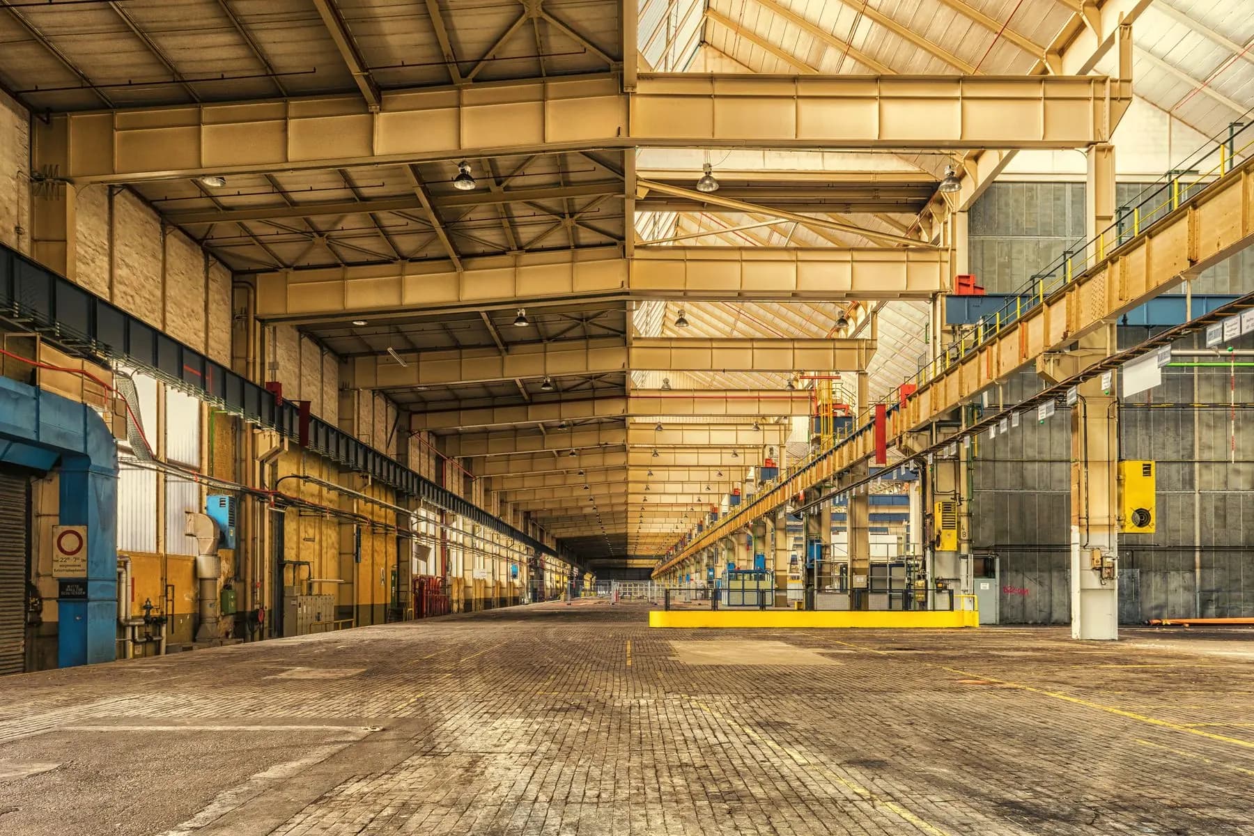 Industrial plant interior with overhead services