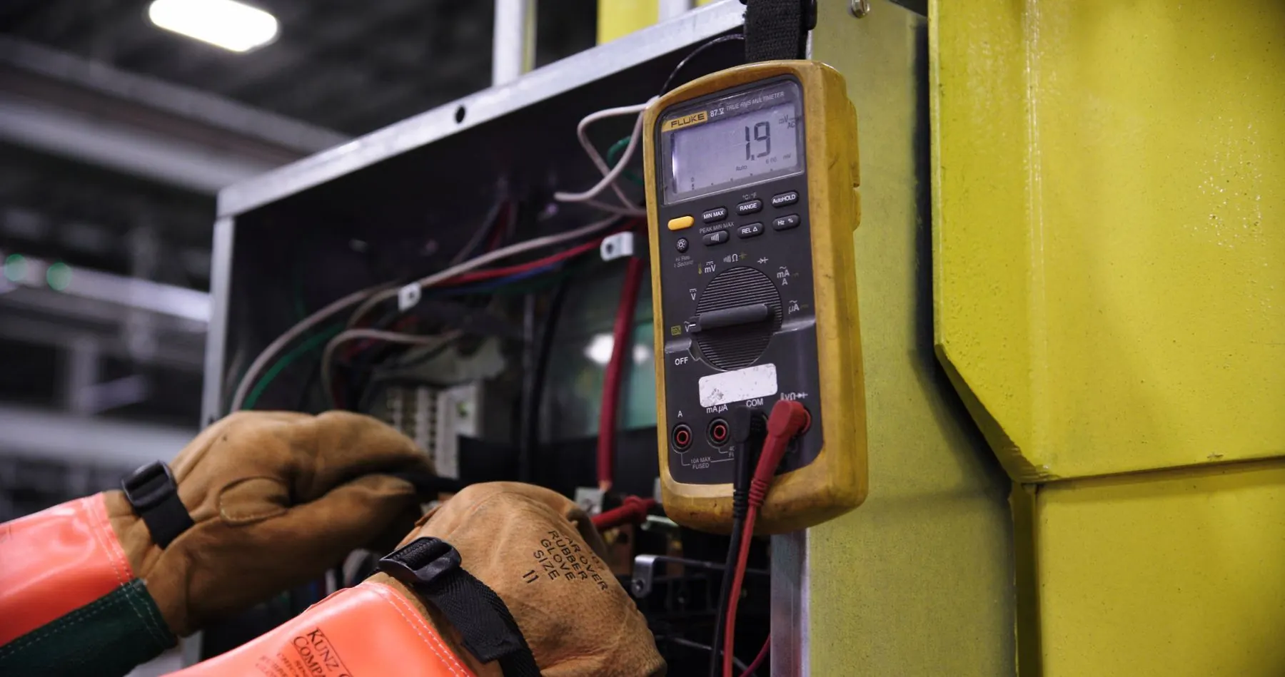 Electrician testing a live circuit with a multimeter